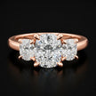 Front view of a cushion cut three stone lab-grown diamond engagement ring in 18kt rose gold.