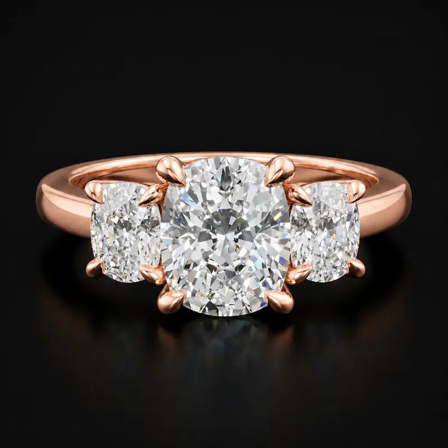 Front view of a cushion cut three stone lab-grown diamond engagement ring in 18kt rose gold.