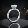 Front view of 4-claw cushion cut engagement ring with hidden halo in 18kt white gold
