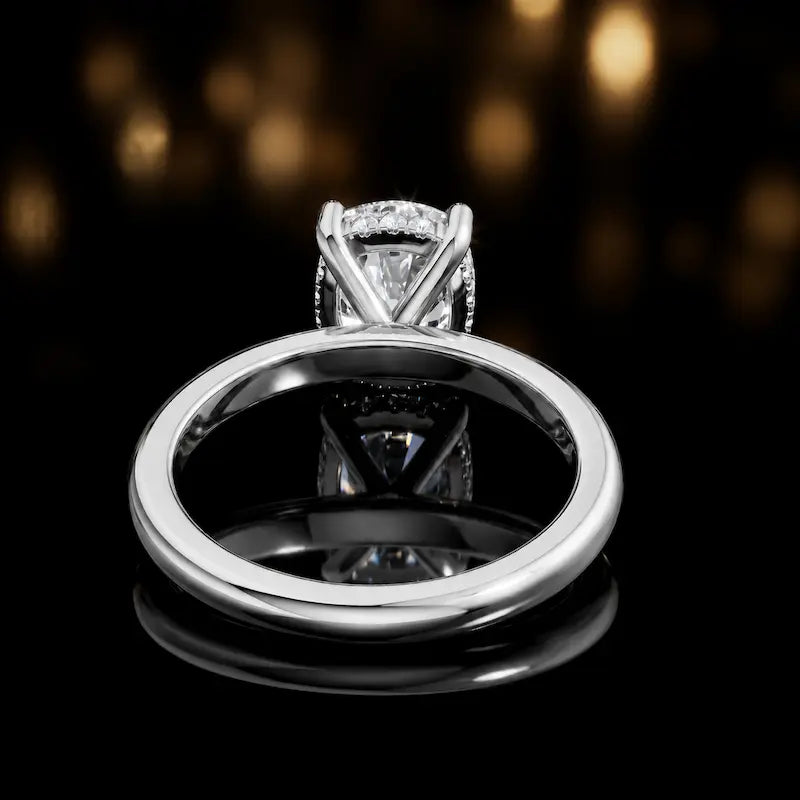 Back view of 4-claw cushion cut engagement ring with hidden halo in 18kt white gold