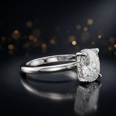 Angled view of 4-claw cushion cut engagement ring with hidden halo in 18kt white gold