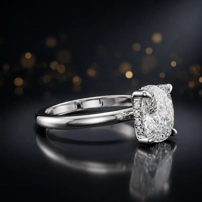 Angled view of 4-claw cushion cut engagement ring with hidden halo in 18kt white gold