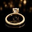 Back view of 4-claw cushion cut engagement ring with hidden halo in 18kt yellow gold