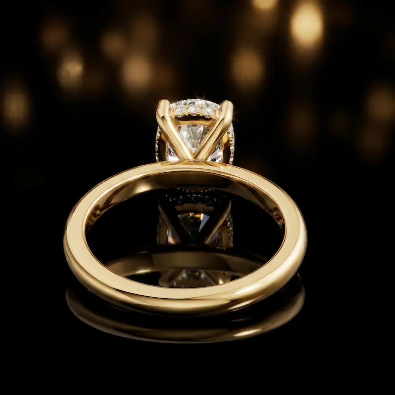 Back view of 4-claw cushion cut engagement ring with hidden halo in 18kt yellow gold