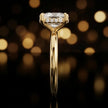 Side profile of 4-claw cushion cut engagement ring with hidden halo in 18kt yellow gold