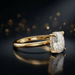 Angled view of 4-claw cushion cut engagement ring with hidden halo in 18kt yellow gold