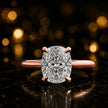 Front view of a 1.5 carat cushion cut diamond solitaire engagement ring in an 18kt rose gold 4 claw setting by TJ Diamond