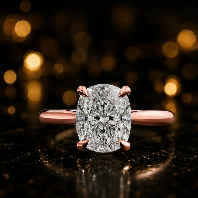 Front view of a 1.5 carat cushion cut diamond solitaire engagement ring in an 18kt rose gold 4 claw setting by TJ Diamond