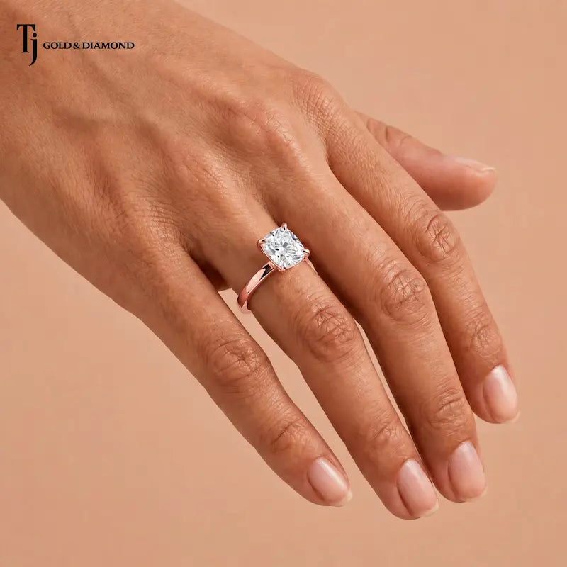 1.5 carat cushion cut lab-grown diamond solitaire engagement ring in 18kt rose gold worn on the hand