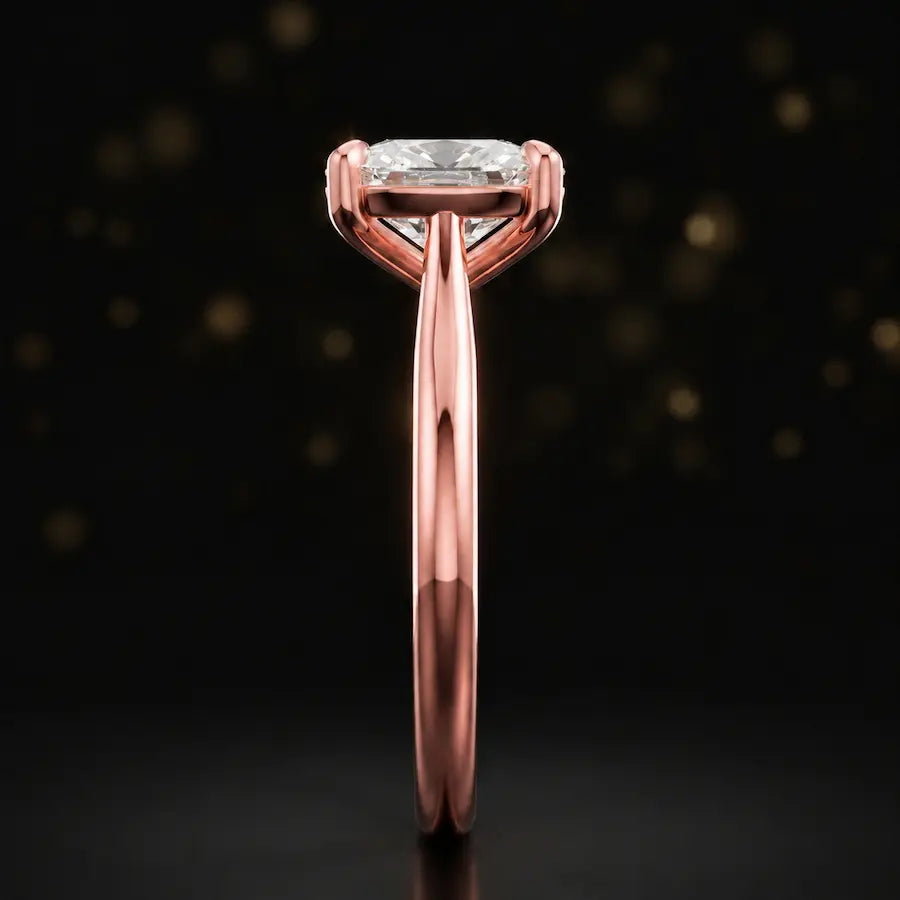 Side profile of a 1.5 carat cushion cut diamond solitaire engagement ring showing the cathedral setting and 18kt rose gold band by TJ Diamond