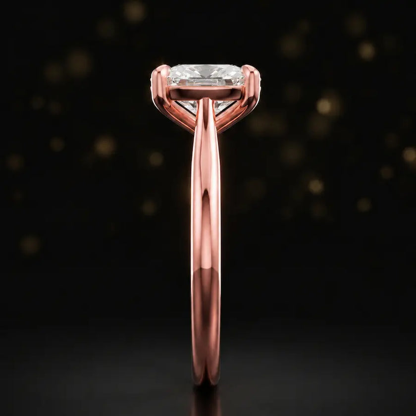 Side profile of a 1.5 carat cushion cut diamond solitaire engagement ring showing the cathedral setting and 18kt rose gold band by TJ Diamond