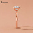 1.5 carat cushion cut lab-grown diamond solitaire engagement ring in 18kt rose gold, raised side view on satin
