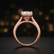 Front-on view of a 1.5 carat cushion cut diamond solitaire engagement ring showing the full 18kt rose gold band and 4 claw cathedral setting by TJ Diamond