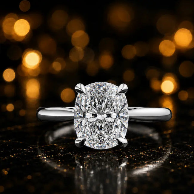 Front view of a 1.5 carat cushion cut diamond solitaire engagement ring in an 18kt white gold 4 claw setting by TJ Diamond