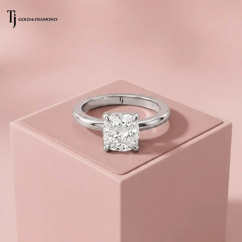 Front view of a 1.5 carat cushion cut lab-grown diamond solitaire engagement ring in 18kt white gold with a 4-claw setting