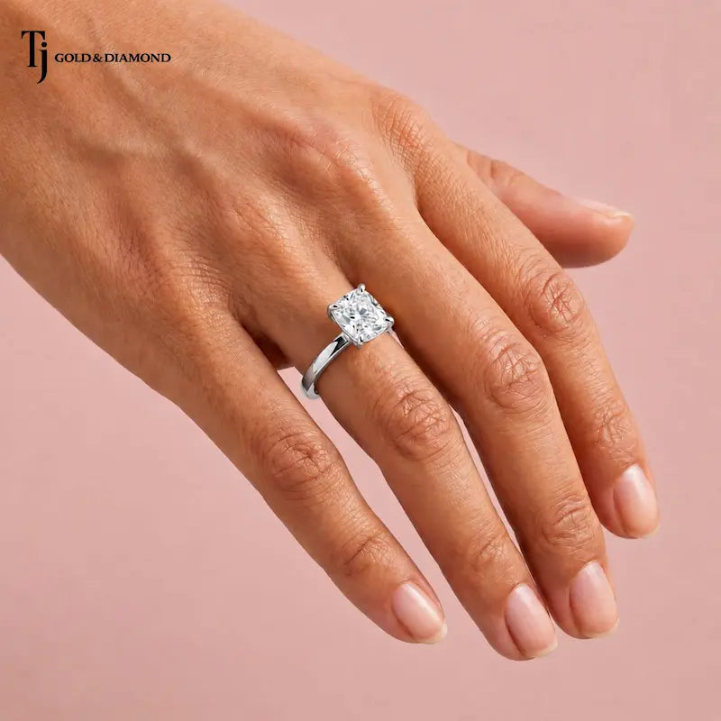 1.5 carat cushion cut lab-grown diamond solitaire engagement ring in 18kt white gold worn on hand