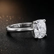 Angled side view of a 1.5 carat cushion cut diamond solitaire engagement ring in an 18kt white gold 4 claw setting by TJ Diamond