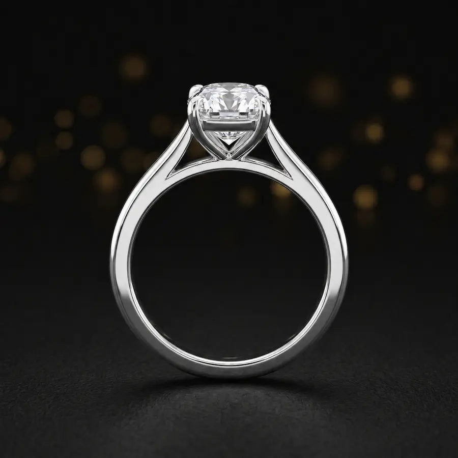 Front-on view of a 1.5 carat cushion cut diamond solitaire engagement ring showing the full 18kt white gold band and 4 claw cathedral setting by TJ Diamond