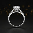 Front-on view of a 1.5 carat cushion cut diamond solitaire engagement ring showing the full 18kt white gold band and 4 claw cathedral setting by TJ Diamond
