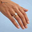 1.5 carat cushion cut lab-grown diamond solitaire engagement ring in 18kt yellow gold worn on hand