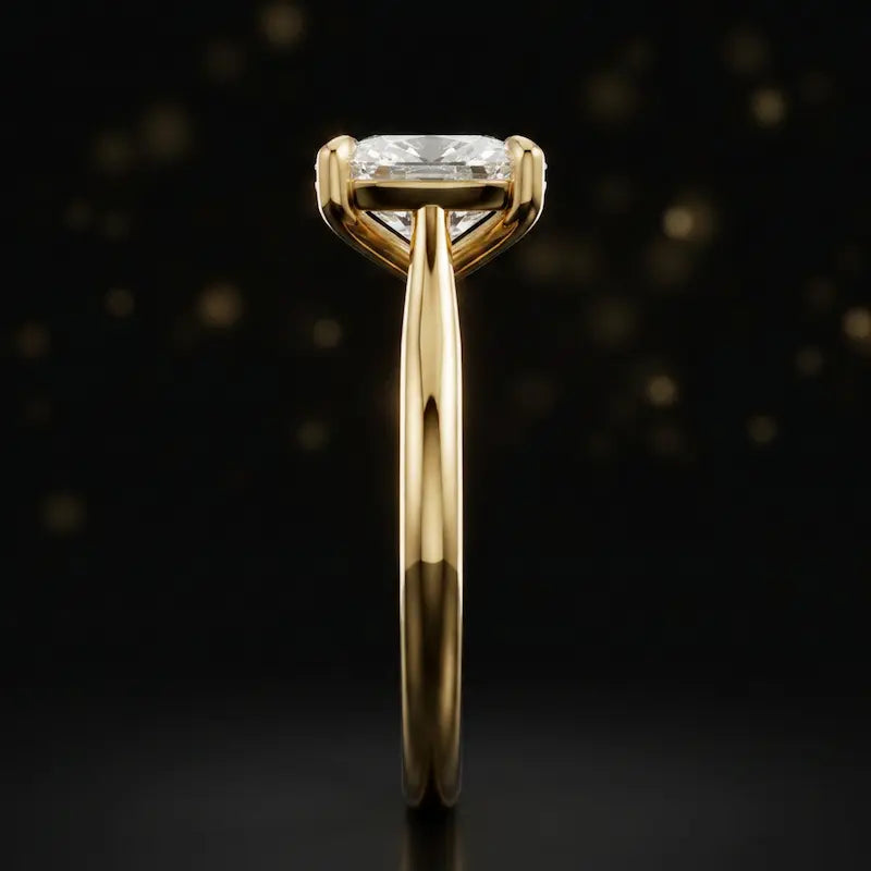 Side profile of a 1.5 carat cushion cut diamond solitaire engagement ring showing the cathedral setting and 18kt yellow gold band by TJ Diamond