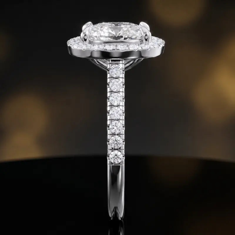 Side profile of a cushion cut halo lab-grown diamond engagement ring in 18kt white gold.