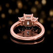 Rear view of an emerald-cut three-stone lab-grown diamond ring in 18ct rose gold, showing the open basket setting.