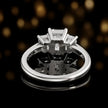 Rear view of an emerald-cut three-stone lab-grown diamond ring in 18ct white gold, showcasing the open basket setting.