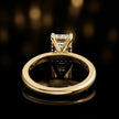 Back view of 4-claw emerald cut engagement ring with hidden halo in 18kt yellow gold