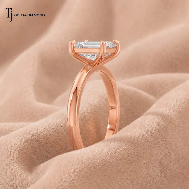  Side profile view of a 1.5 carat emerald cut lab-grown diamond solitaire engagement ring in 18kt rose gold