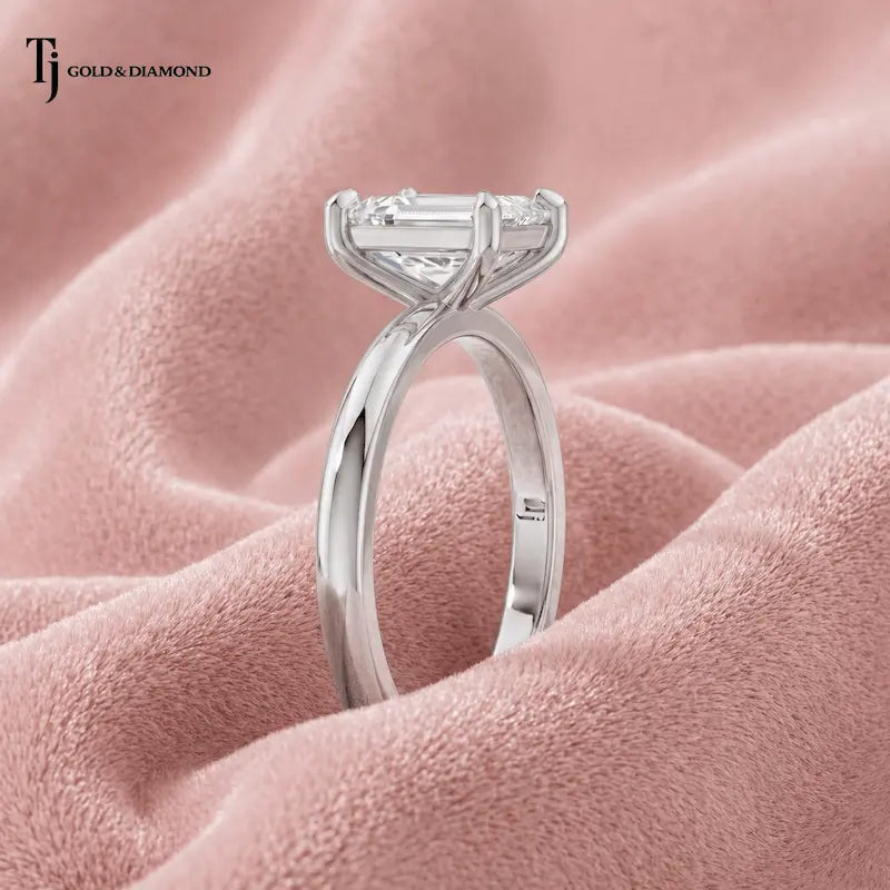 Side profile view of a 1.5 carat emerald cut lab-grown diamond solitaire engagement ring in 18kt white gold