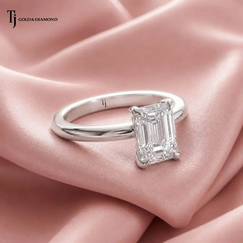 Side view of a 1.5 carat emerald cut lab-grown diamond solitaire engagement ring in 18kt white gold on satin