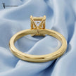 Back view of a 1.5 carat emerald cut lab-grown diamond solitaire engagement ring in 18kt yellow gold with a 4-claw setting