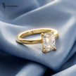 Front view of a 1.5 carat emerald cut lab-grown diamond solitaire engagement ring in 18kt yellow gold with a 4-claw setting