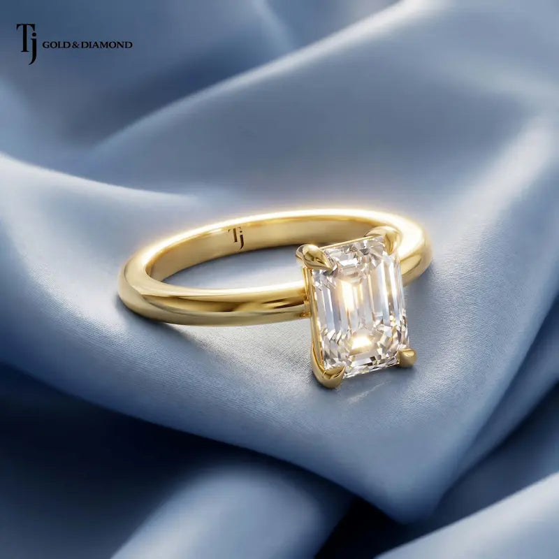 Front view of a 1.5 carat emerald cut lab-grown diamond solitaire engagement ring in 18kt yellow gold with a 4-claw setting