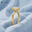 Side angle view of a 1.5 carat emerald cut lab-grown diamond solitaire engagement ring in 18kt yellow gold with a 4-claw setting