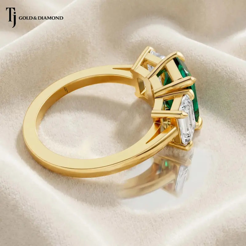 Side view of an Emerald Cut Lab-Created Emerald & Lab-Grown Diamond Trilogy Ring in 18kt yellow gold.