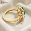 Side view of an Emerald Cut Lab-Created Emerald & Lab-Grown Diamond Trilogy Ring in 18kt yellow gold.