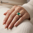 Emerald Cut Lab-Created Emerald & Lab-Grown Diamond Trilogy Ring worn on the hand in 18kt yellow gold.