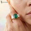 Model wearing an Emerald Cut Lab-Created Emerald & Lab-Grown Diamond Trilogy Ring in 18kt yellow gold.