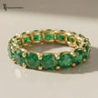 Created emerald full eternity ring in 18kt yellow gold featuring 1.5mm round brilliant lab-created emeralds in a shared prong setting.