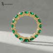 Created emerald full eternity ring in 18kt yellow gold featuring 1.5mm round brilliant lab-created emeralds displayed upright.