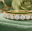 Close-up of Claw Fish Tail Half Eternity diamond wedding band in 18kt yellow gold, showing round brilliant diamonds and fish tail claw detail