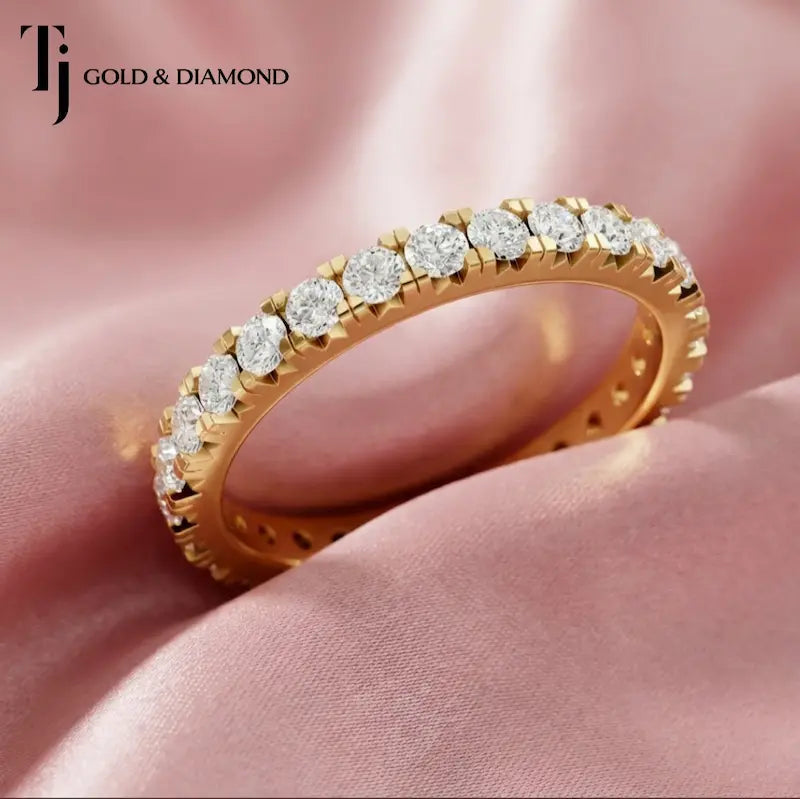 Luxury fish tail setting full eternity diamond wedding band crafted in 18kt yellow gold with round brilliant lab-grown diamonds.