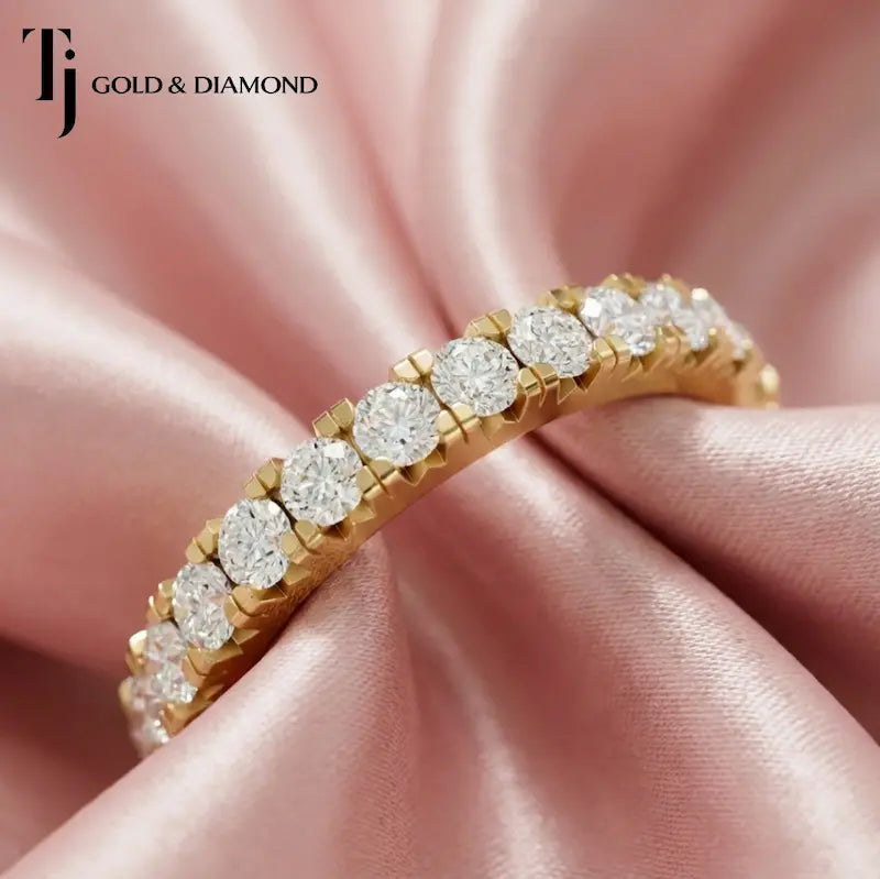 Fish tail setting full eternity diamond wedding band in 18kt yellow gold with round brilliant lab-grown diamonds.