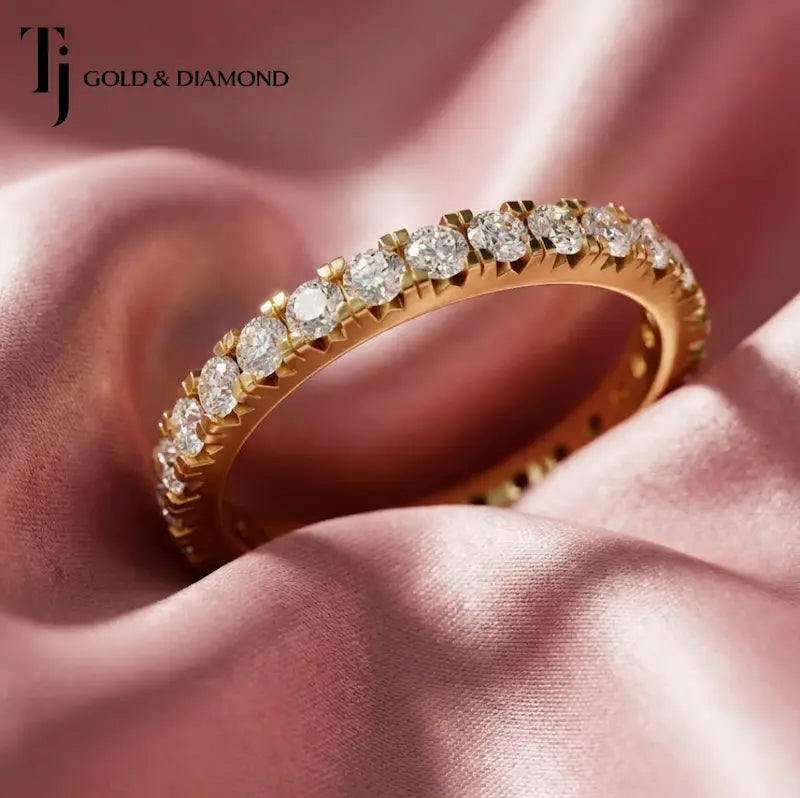 Full eternity diamond wedding band featuring a fish tail setting in 18kt yellow gold with round brilliant lab-grown diamonds.