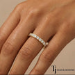 Model wearing a fish tail setting full eternity diamond wedding band in 18kt yellow gold with round brilliant lab-grown diamonds.