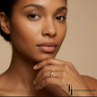 Model wearing a flush setting full eternity diamond wedding band in 18kt yellow gold with round brilliant lab-grown diamonds.