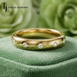 Front view of Flush Half Eternity diamond wedding band in 18kt yellow gold, round brilliant diamonds set flush into smooth band