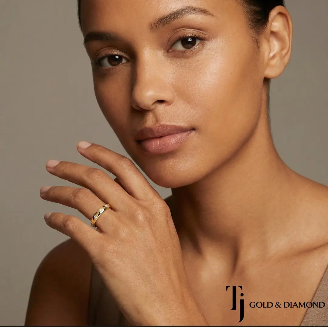 Model wearing Flush Half Eternity diamond wedding band in 18kt yellow gold, close-up lifestyle shot